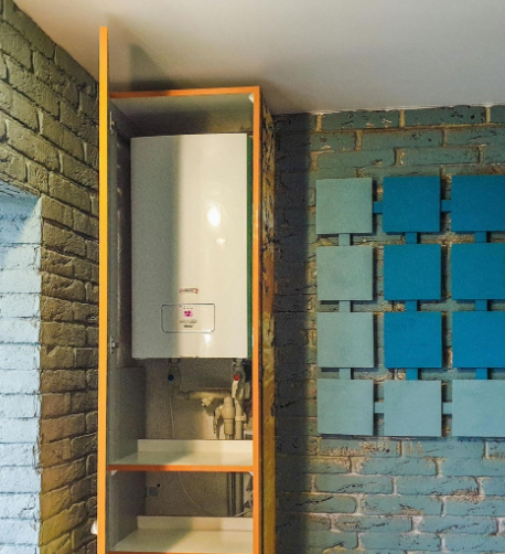 Compact tankless water heater installed inside wall cabinet