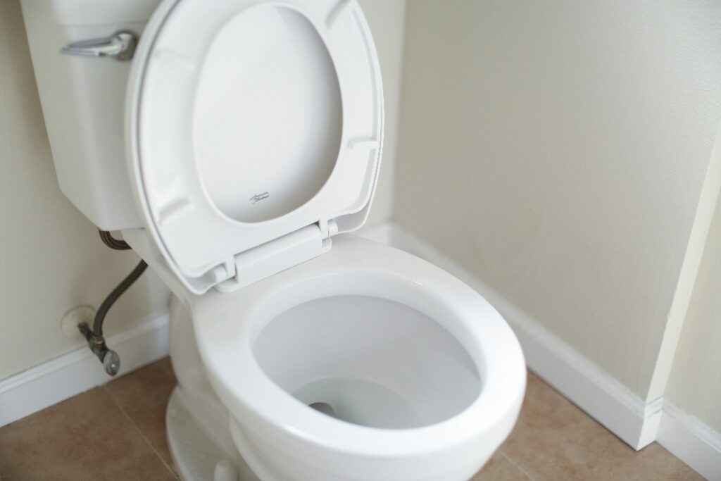 Clean white toilet installed in residential bathroom