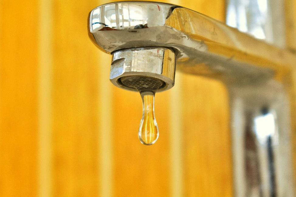Water droplet falling from a chrome sink faucet
Caption: Dripping faucet illustrating a common hidden leak that can waste water over time.