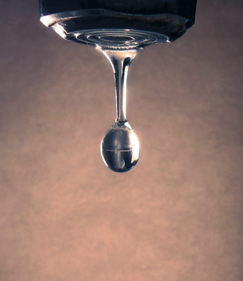  Close-up of water droplet forming under faucet spout