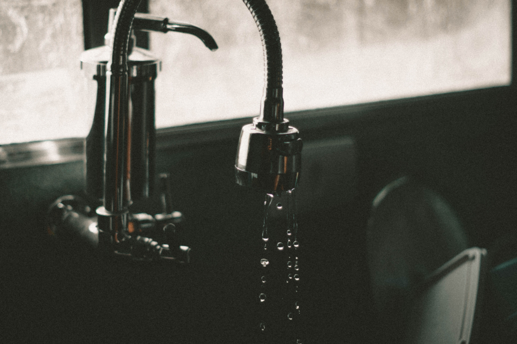 Water dripping slowly from a residential sink faucet