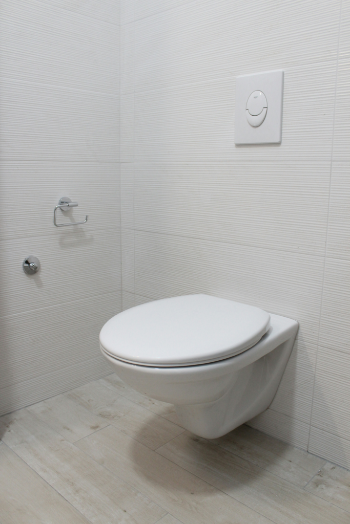White toilet installed on a residential bathroom floor