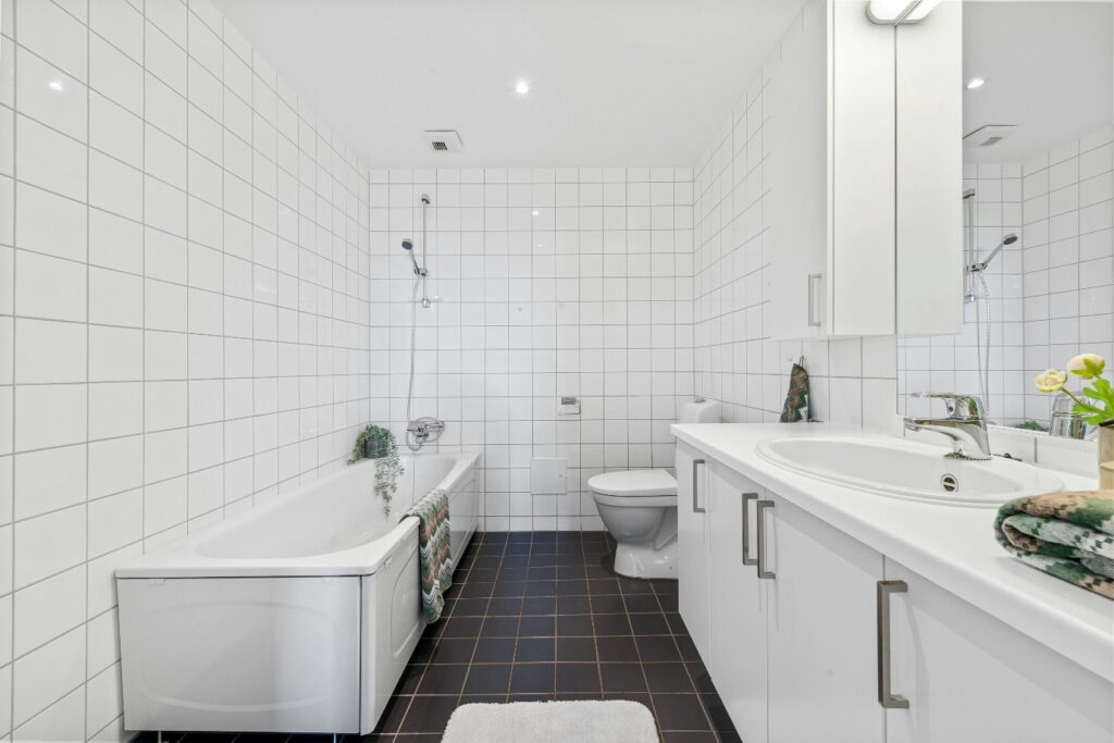 Residential bathroom containing a toilet, sink, and bathtub