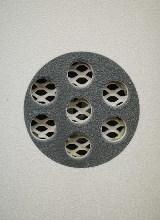 A round floor drain set into flooring